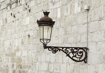 Old lamppost on a wall