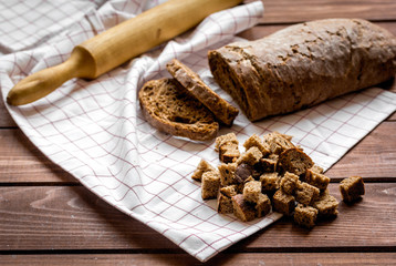 Dried crumbs with bread on kitchen table background