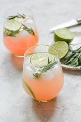 healthy morning with fresh drink, lime and rosemary on stone table background