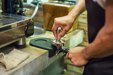 A Man prepares espresso
