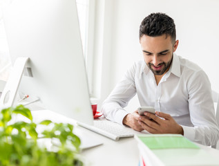 Young businessman working at office on computer desk