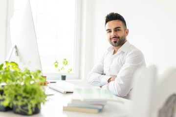 Young businessman working at office on computer desk