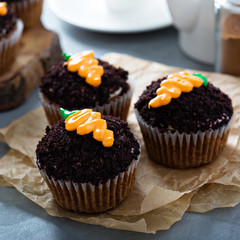 Carrot cupcakes with chocolate crumbs and frosting