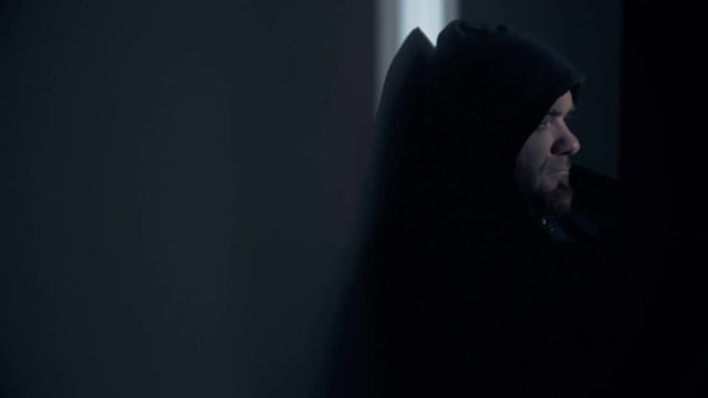 Portrait of  depressed hooded man in the darkness