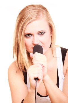 Blonde woman singing to microphone