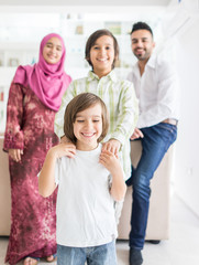 Happy Arabic Muslim family at modern home having fun and good time together