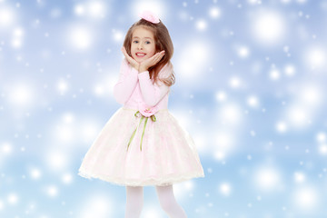 Fototapeta na wymiar Elegant little girl in a pink dress.