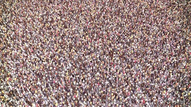 Huge Anonymus Crowd Fly Over. Tracking Shot. Zoom In.