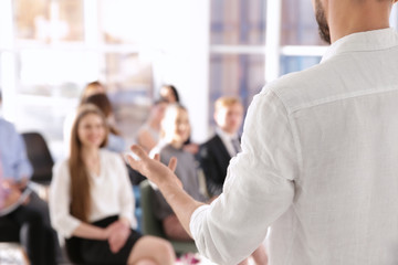 Business trainer giving presentation to group of people