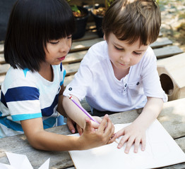 Children are drawing some idea together