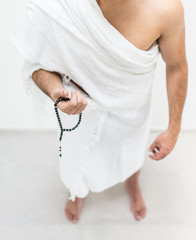 Muslim man posing as ready for Hajj visiting Kaaba in Mecca