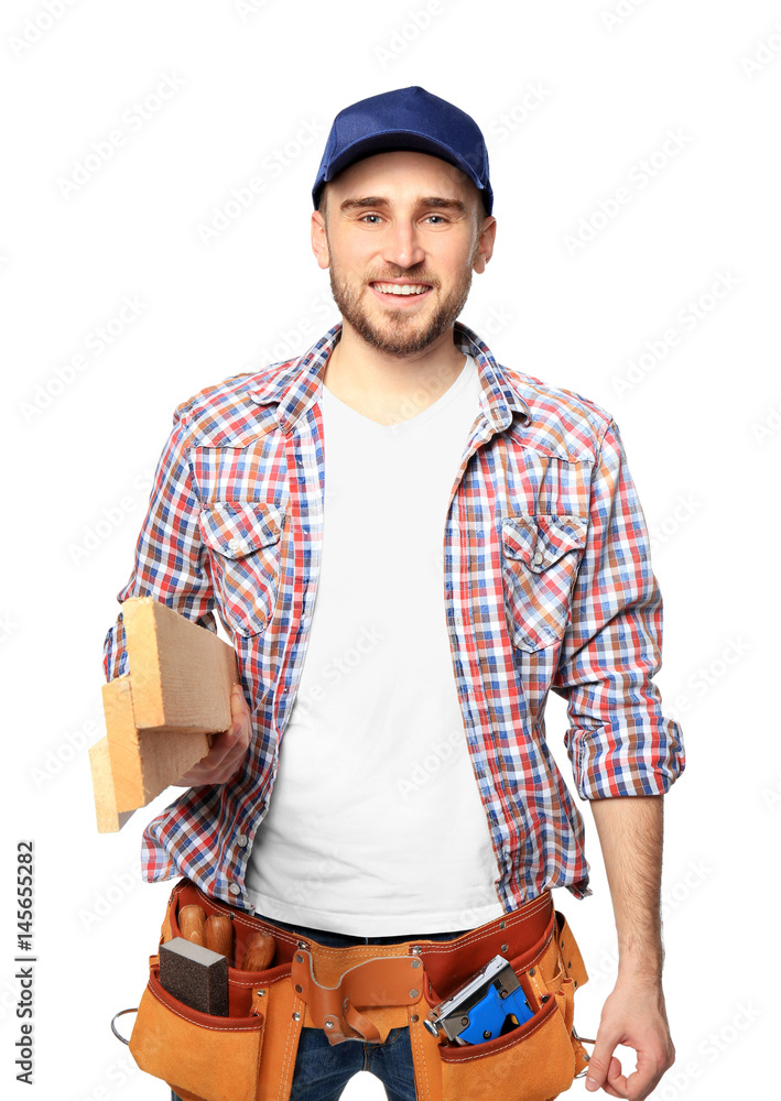 Wall mural handsome young carpenter on white background