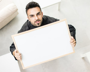 Attractive Arabic young man with white board for your message or text