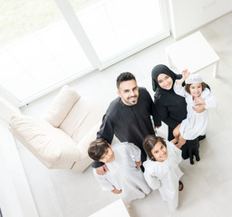 High angle view portrait of happy Arabic Muslim family at new modern home
