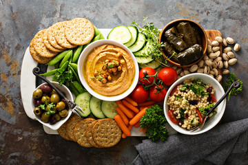 Hummus and vegetables platter with grain salad