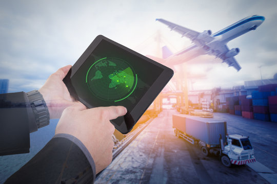 Hand presses on tablet with radar targets in action,Management logistics of Industrial Container Cargo for Import Export business. (Elements of this image furnished by NASA)