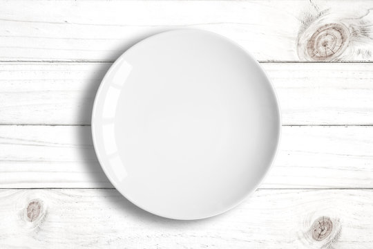 Top View Of Blank White Dish On A Wood Background.