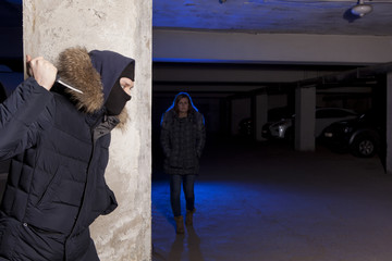 Criminal with knife waiting for a woman