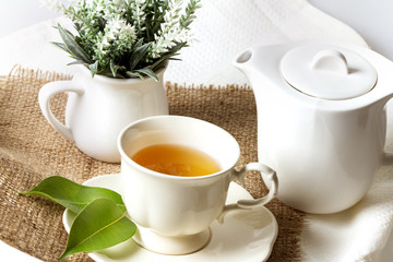 Close up organic tea in white cup with green leaf , Tea ceremony time concept