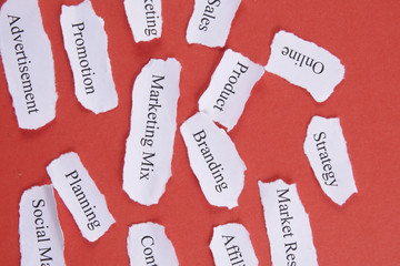 Marketing conceptual word on torn paper.