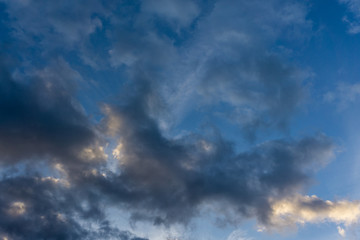Naklejka na ściany i meble Blue sky with dark clouds as background