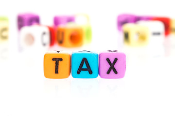 colorful word cube of TAX on white background