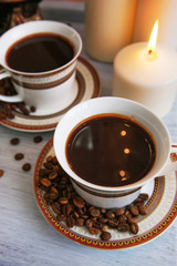 Coffee beens and candles in a glass vase