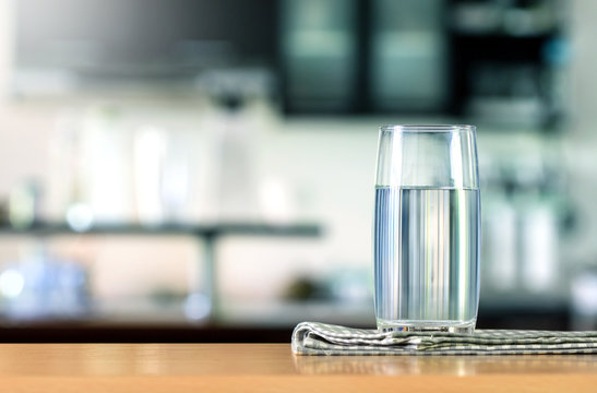 Glass of purified water on  table bar in kitchenroom