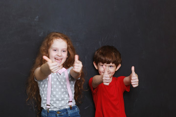 Laughing children showing thumbs up. Give like.