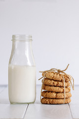 Biscuits with milk on wood background in the morning