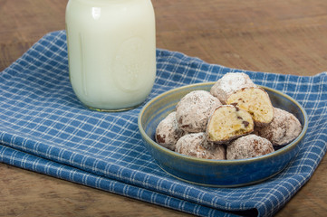 Rolled and sugared cookies with milk