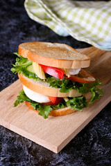 Club sandwich with cheese, cucumber, tomato and eggs