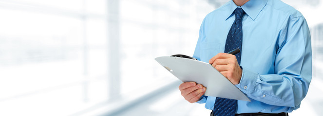 Businessman hands with clipboard