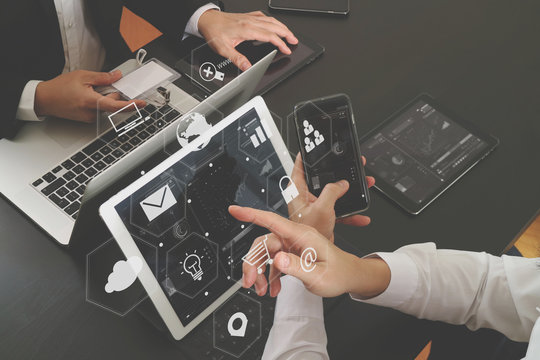 co working team meeting concept,businessman using smart phone and digital tablet and laptop computer and name tag in modern office