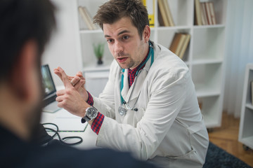 Patient and young doctor talking about patients problems