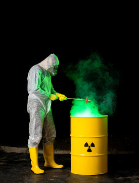 biohazard worker grilling sausage over radioactive green smoke coming out from yellow barrel