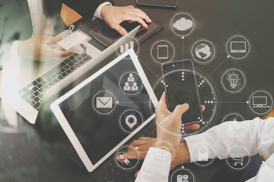 co working team meeting concept,businessman using smart phone and digital tablet and laptop computer and name tag in modern office