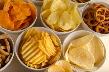 Pretzels in bowls on wooden table from above