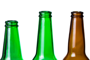 Green and brown glass bottles necks isolated on white.