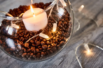 Coffee beens and candles in a glass vase