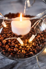 Coffee beens and candles in a glass vase