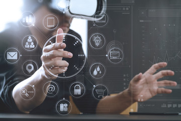 businessman wearing virtual reality goggles in modern office with Smartphone using with VR headset