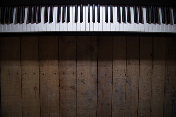 piano on wooden background closeup