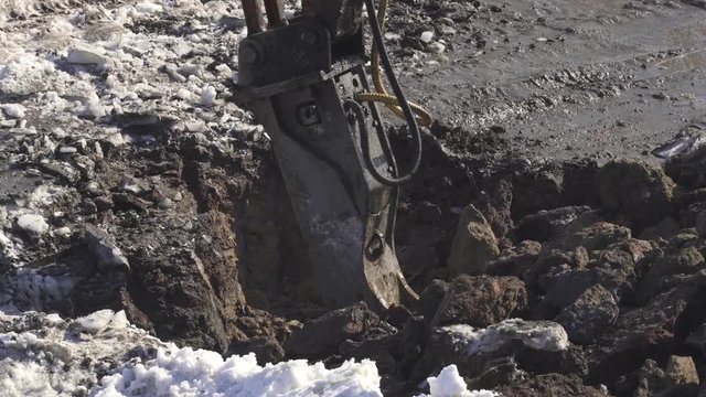 Breaker (hydraulic) cuts frozen soil Timelapse stock footage video