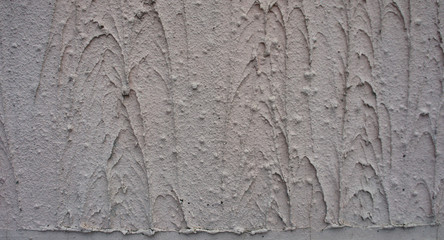 Texture - the wall is covered with light gray coarse plaster.