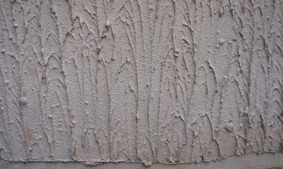 Texture - the wall is covered with light gray coarse plaster.