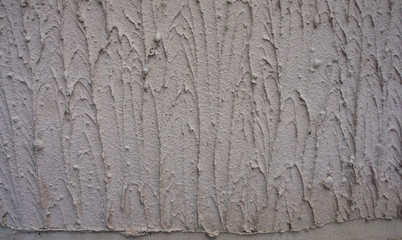 Texture - the wall is covered with light gray coarse plaster.