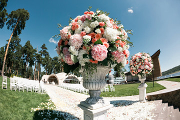 Beautiful wedding ceremony design decoration elements with fresh flowers composition, floral...