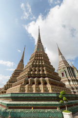 Fototapeta premium Several ornate chedis at the Wat Pho (Po) temple complex in Bangkok, Thailand, viewed from the front.
