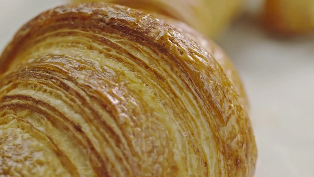 Tracking macro shot of delicious just baked croissant made of layered dough